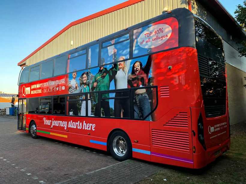 Red double-decker bus advertising wrap