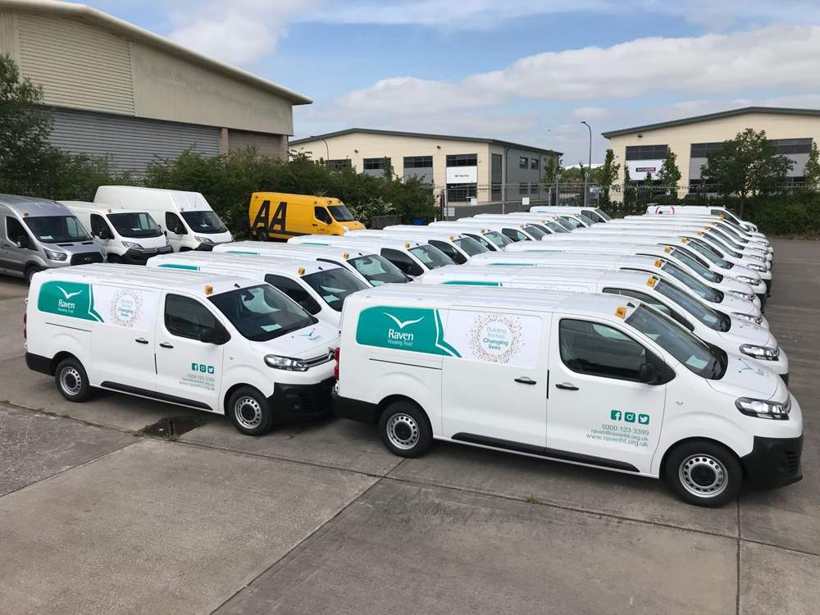 Fleet of white vans awaiting livery